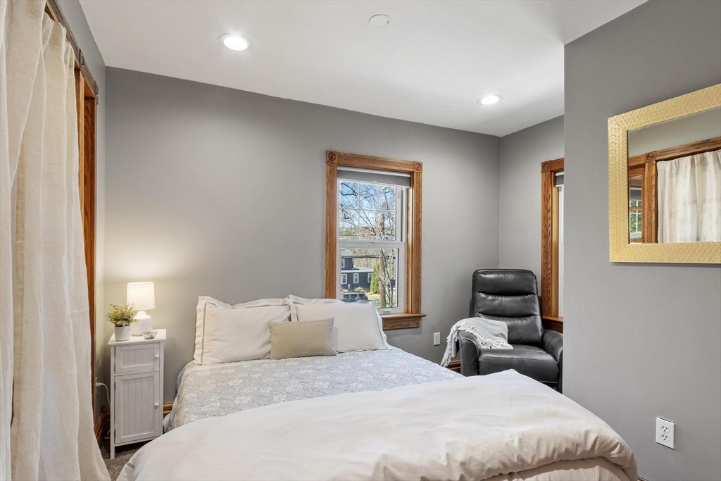 203 Main Street Acton, MA 01720 - Photo 33 of 42 a bedroom with a bed and wooden floor