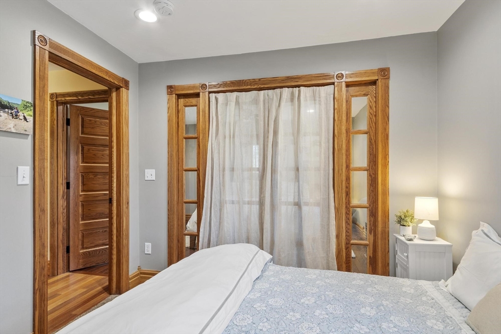 203 Main Street Acton, MA 01720 - Photo 34 of 42 a bedroom with a bed and a large window
