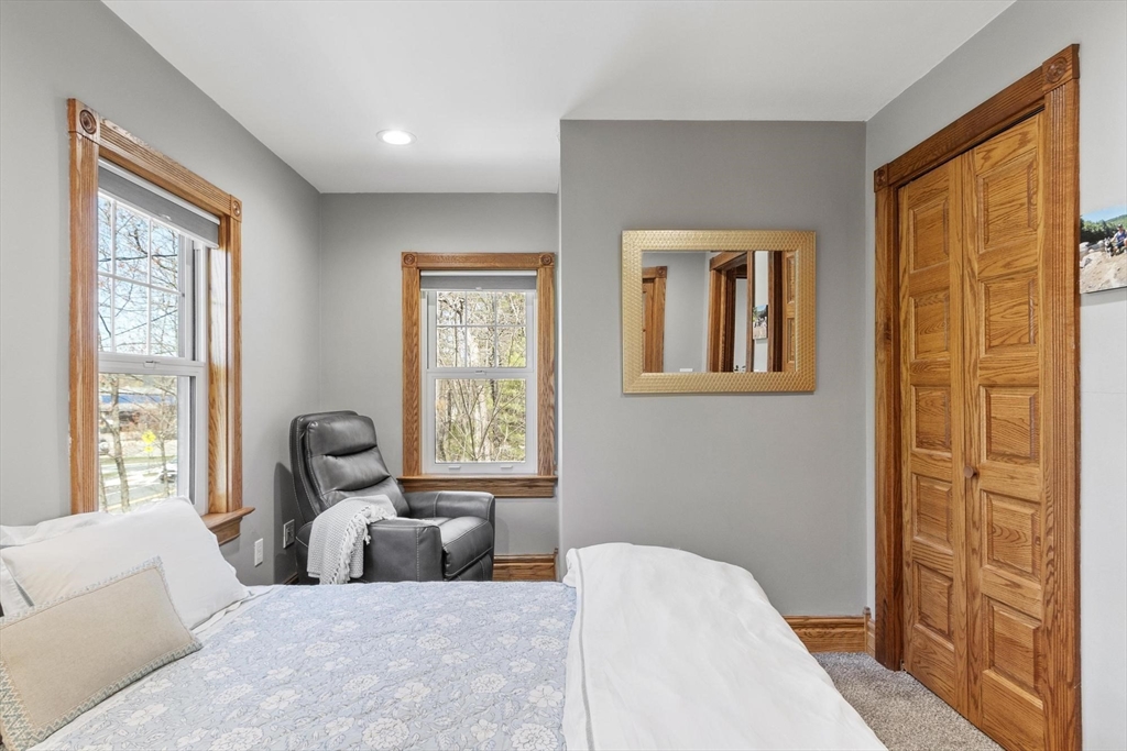 203 Main Street Acton, MA 01720 - Photo 36 of 42 a bedroom with a bed and wooden floor