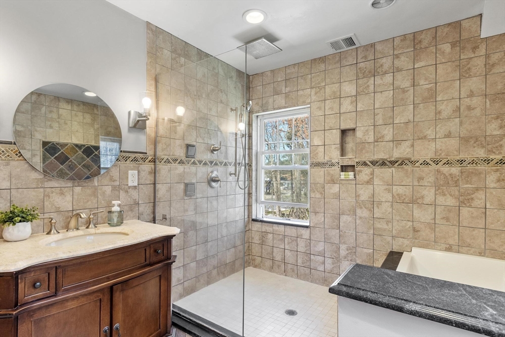 203 Main Street Acton, MA 01720 - Photo 38 of 42 a bathroom with a granite countertop sink a mirror and shower