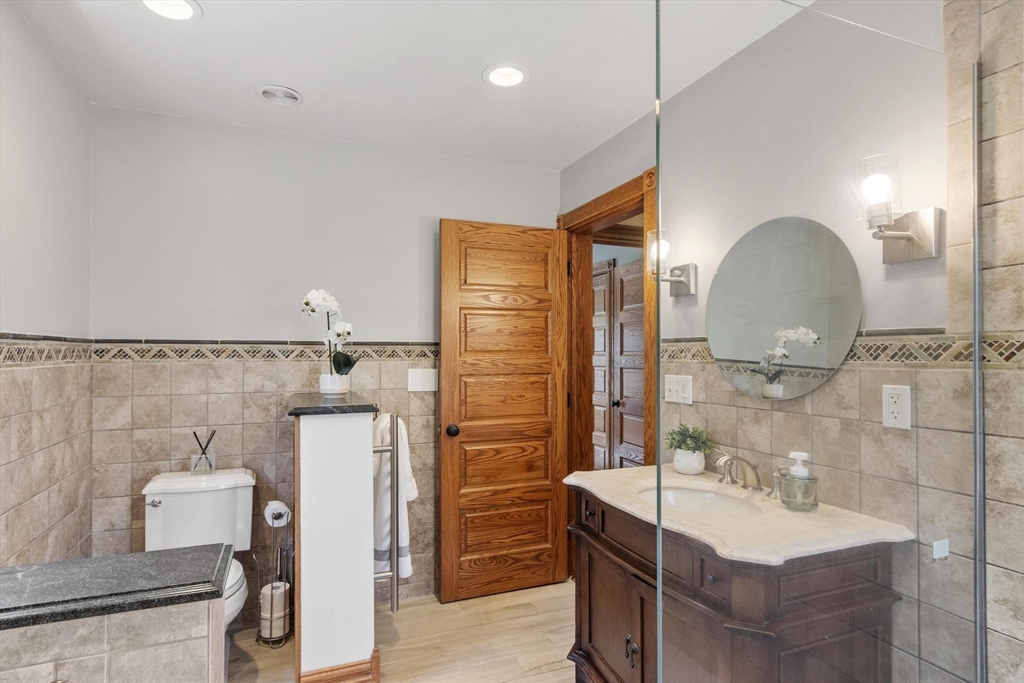 203 Main Street Acton, MA 01720 - Photo 39 of 42 a bathroom with a sink and a mirror