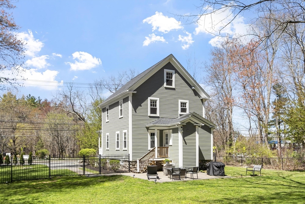 203 Main Street Acton, MA 01720 - Photo 6 of 42 a front view of a house with a yard