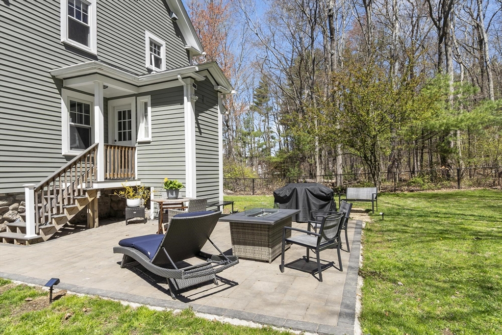 203 Main Street Acton, MA 01720 - Photo 8 of 42 a view of a backyard with a patio