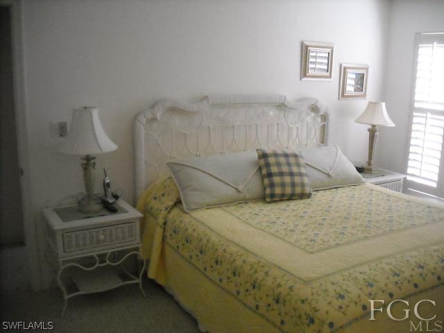 491 Rabbit Road Sanibel, FL 33957 - Photo 7 of 9 a bedroom with a bed and a window
