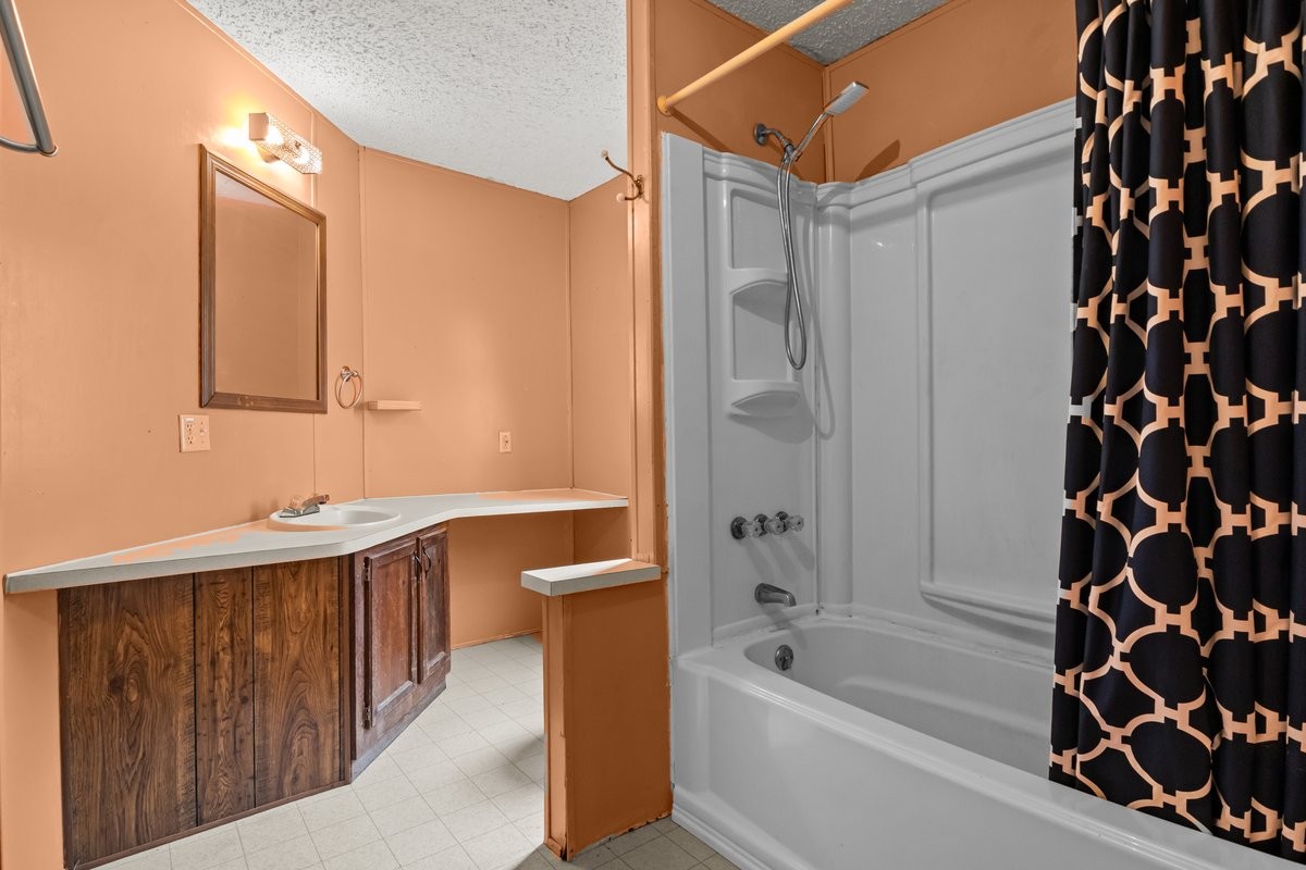 6495 Divider And Natchez Trace Road Camden, TN 38320 - Photo 15 of 31 a bathroom with a bathtub a sink and a shower