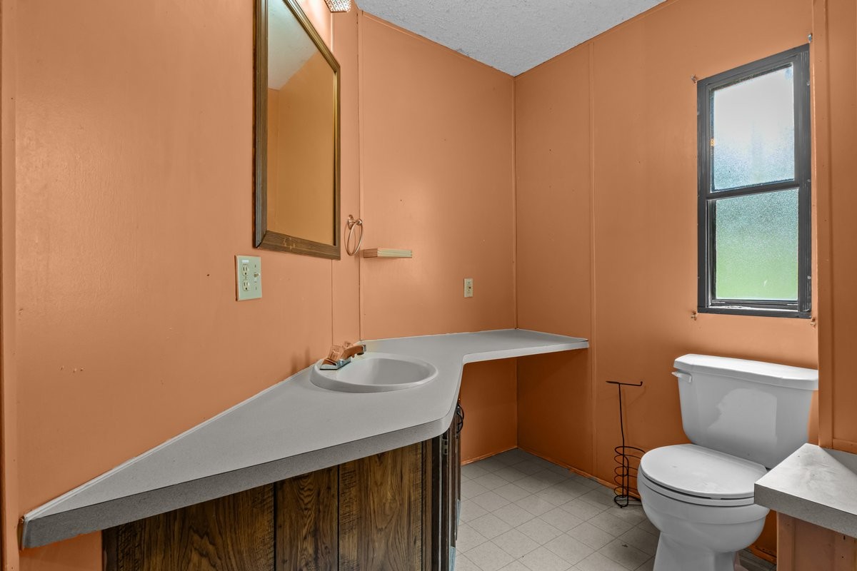 6495 Divider And Natchez Trace Road Camden, TN 38320 - Photo 16 of 31 a bathroom with a sink a toilet and mirror
