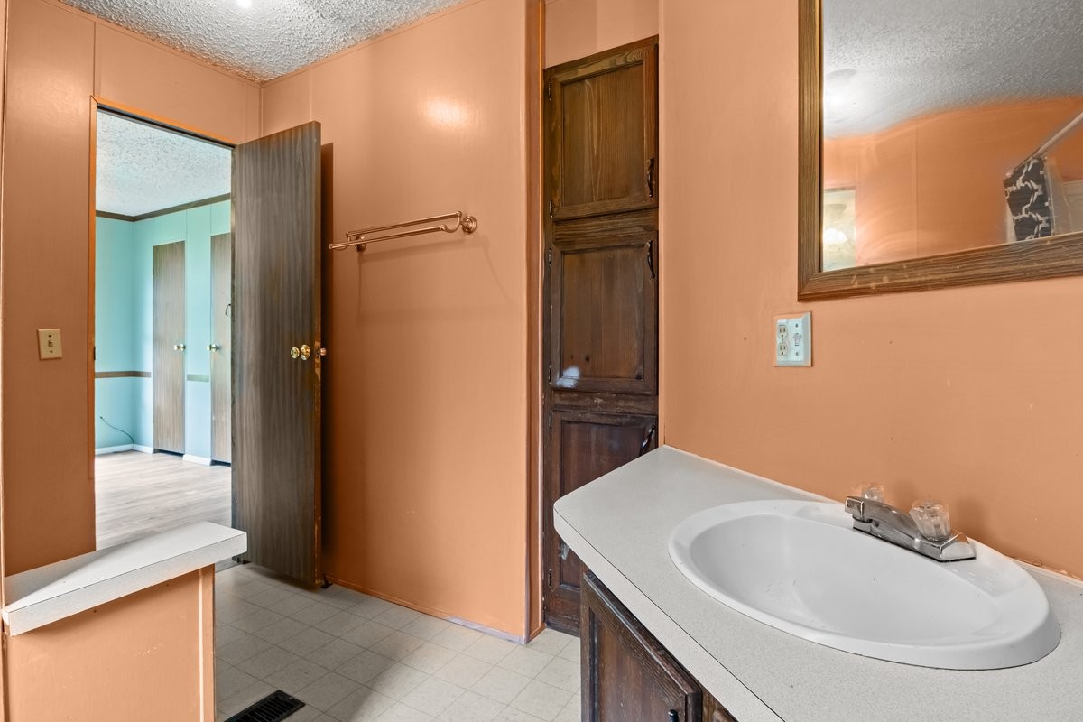 6495 Divider And Natchez Trace Road Camden, TN 38320 - Photo 17 of 31 a bathroom with a sink and a mirror