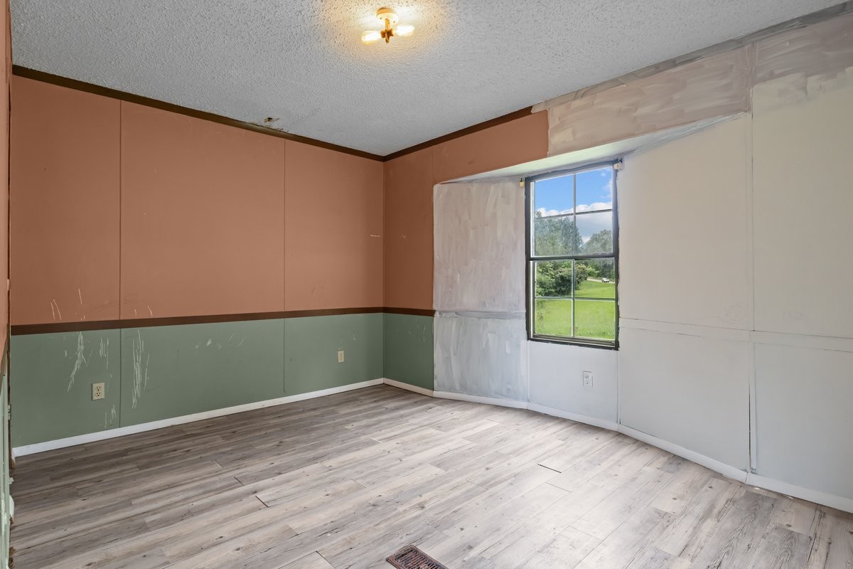 6495 Divider And Natchez Trace Road Camden, TN 38320 - Photo 18 of 31 an empty room with wooden floor and windows