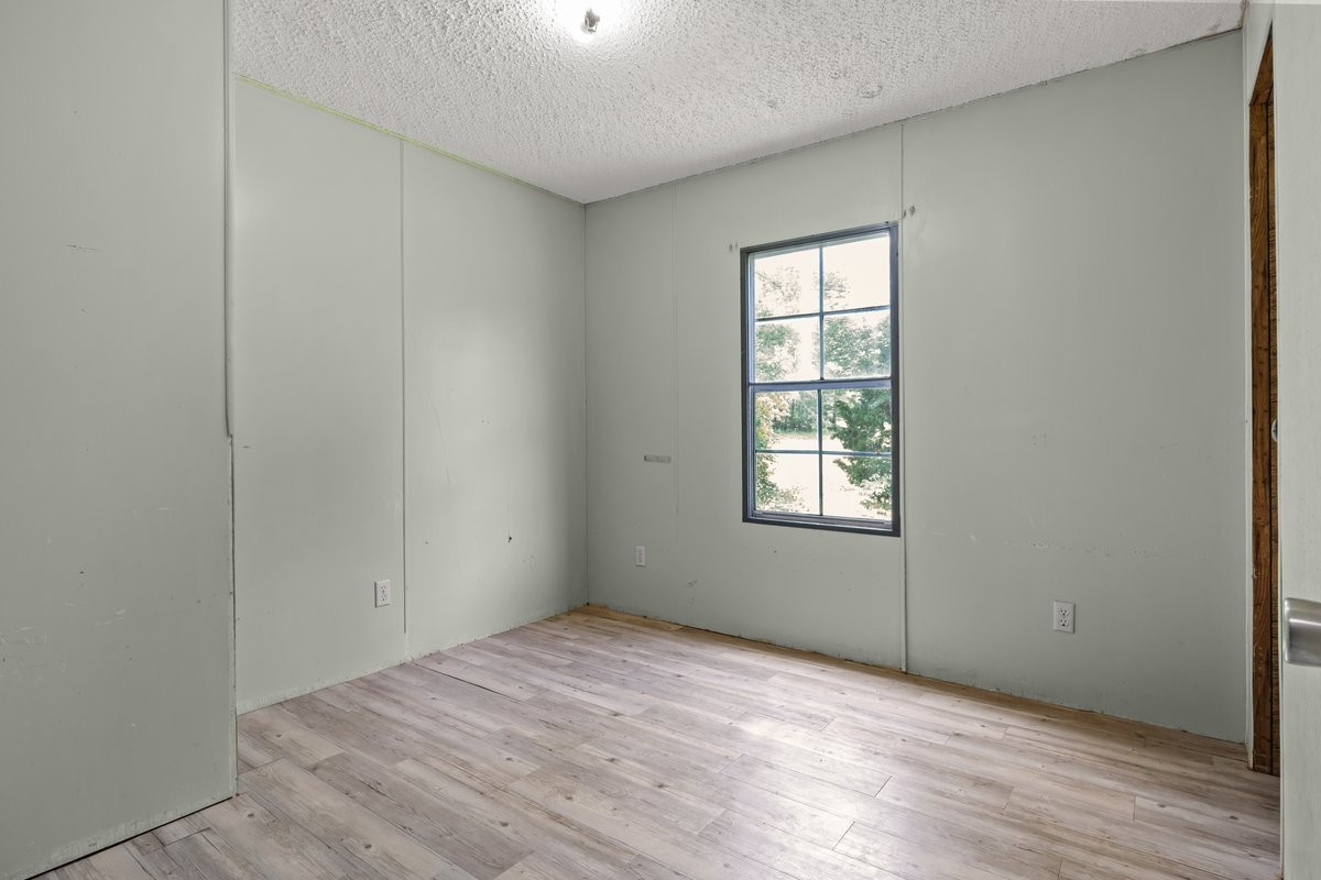 6495 Divider And Natchez Trace Road Camden, TN 38320 - Photo 21 of 31 an empty room with wooden floor and windows
