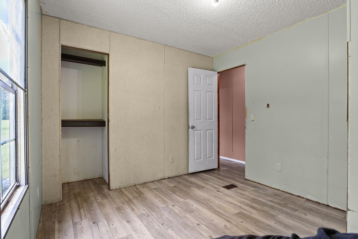 6495 Divider And Natchez Trace Road Camden, TN 38320 - Photo 22 of 31 an empty room with wooden floor closet and windows