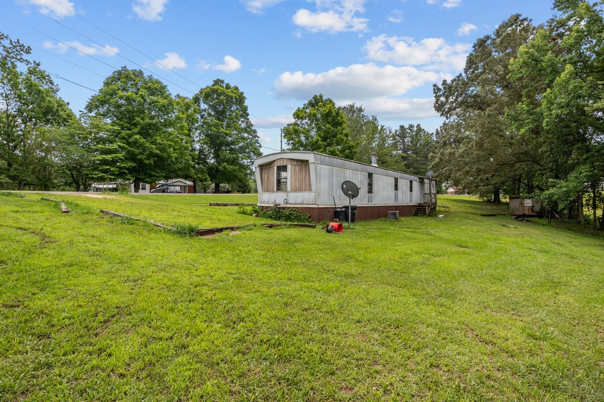 6495 Divider And Natchez Trace Road Camden, TN 38320 - Photo 25 of 31 a view of a house with a big yard