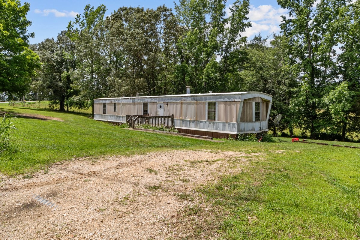 6495 Divider And Natchez Trace Road Camden, TN 38320 - Photo 3 of 31 a view of a house with backyard and sitting area