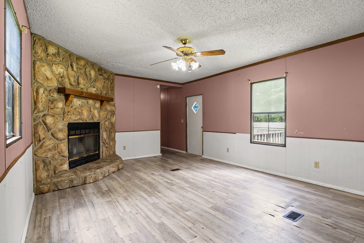 6495 Divider And Natchez Trace Road Camden, TN 38320 - Photo 7 of 31 a view of an empty room with a window and fireplace