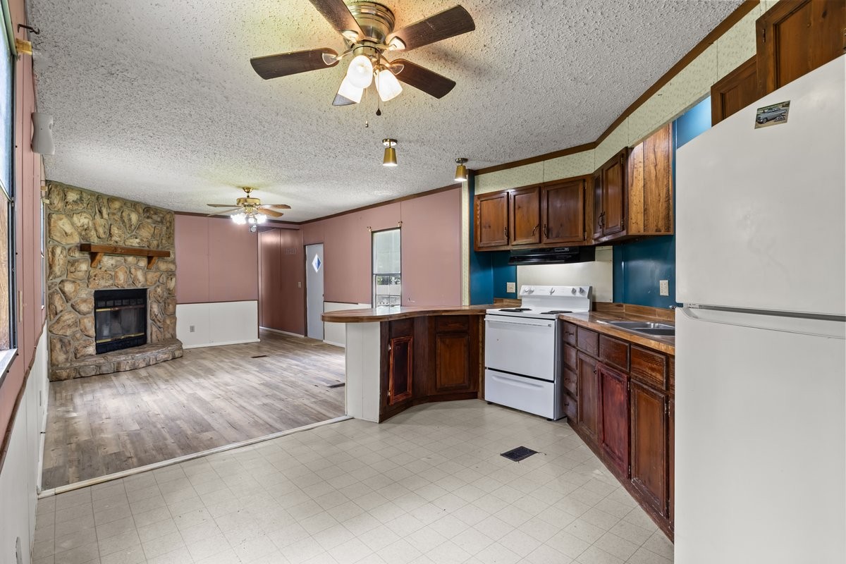 6495 Divider And Natchez Trace Road Camden, TN 38320 - Photo 8 of 31 a kitchen with a refrigerator sink and cabinets
