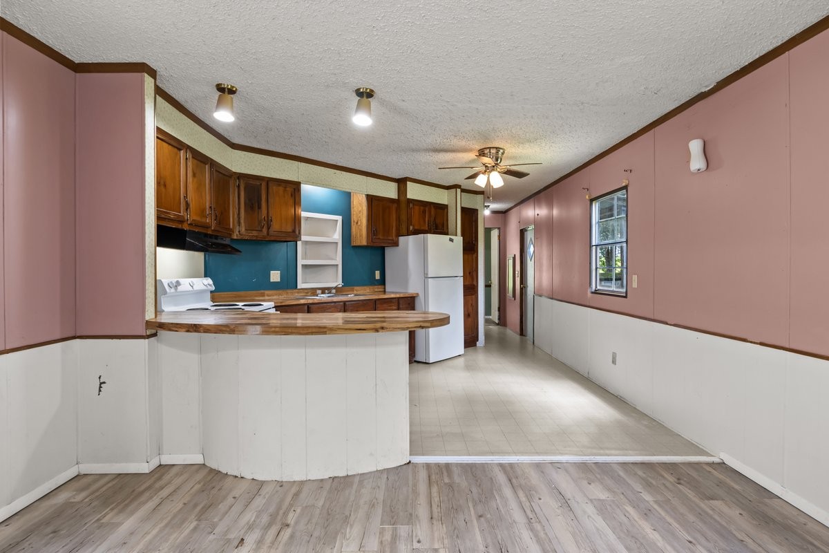 6495 Divider And Natchez Trace Road Camden, TN 38320 - Photo 10 of 31 a kitchen with stainless steel appliances granite countertop a sink stove and refrigerator