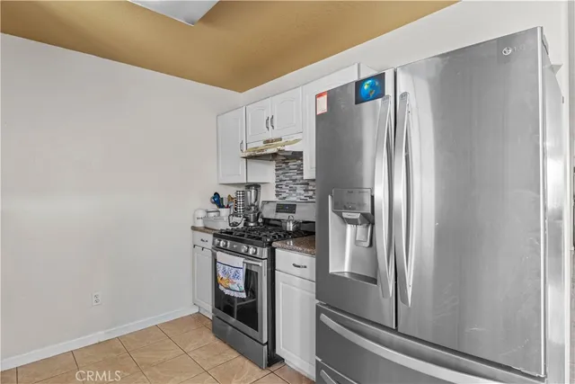 a kitchen with stainless steel appliances a refrigerator stove and sink