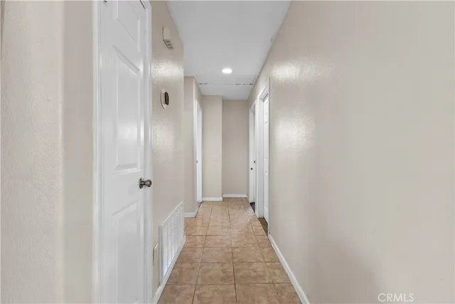 a view of a hallway with wooden shelves
