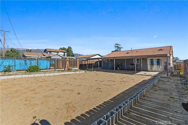 a view of a house with wooden fence