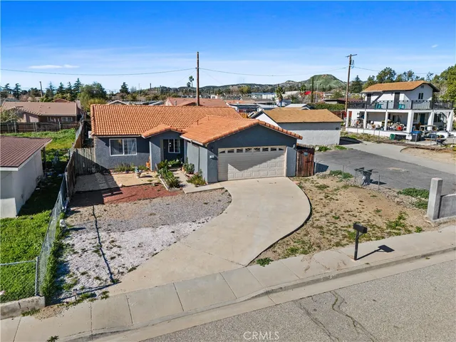an aerial view of a house with a yard and lake view