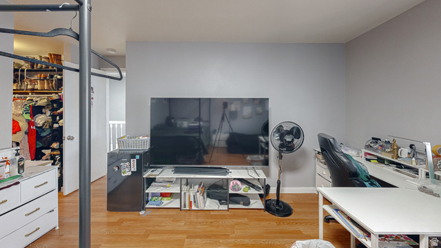 630 1100 West Provo, UT 84601 - Photo 30 of 64 Interior space featuring wood-finish flooring, light grey painted walls, and white baseboards