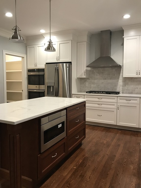 57 Wellesley Rd Extension Natick, MA 01760 - Photo 2 of 26 a kitchen with stainless steel appliances kitchen island granite countertop a stove a sink and a refrigerator