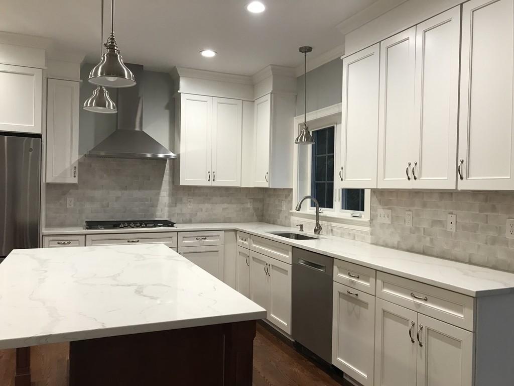 57 Wellesley Rd Extension Natick, MA 01760 - Photo 4 of 26 a kitchen with a sink a stove and cabinets