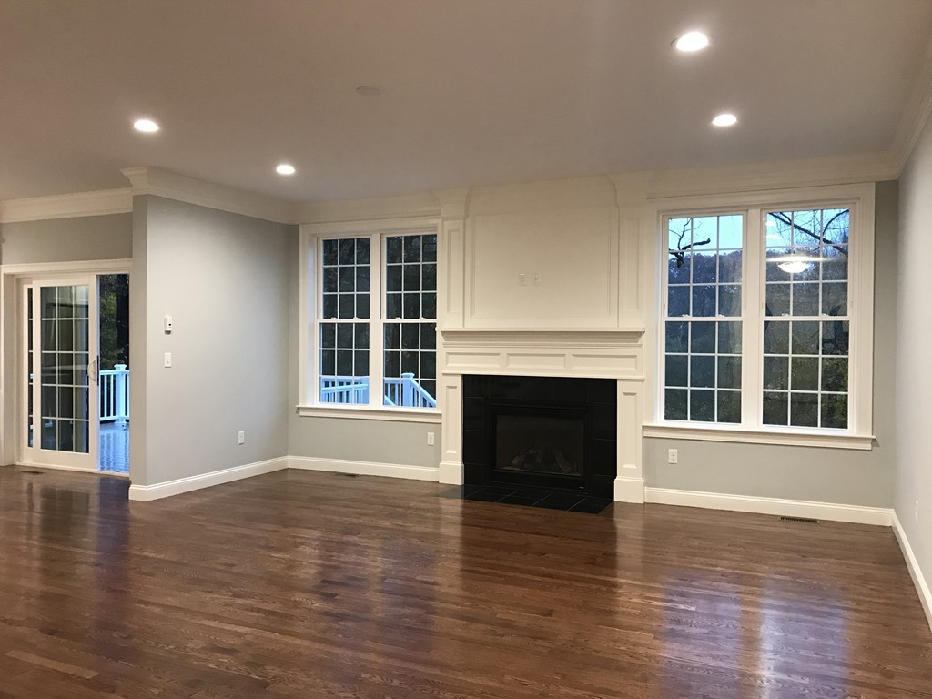 57 Wellesley Rd Extension Natick, MA 01760 - Photo 9 of 26 a view of empty room with wooden floor and fireplace