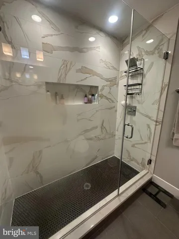 a bathroom with a shower and a shower