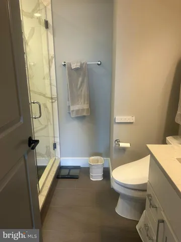 a bathroom with a toilet and a shower