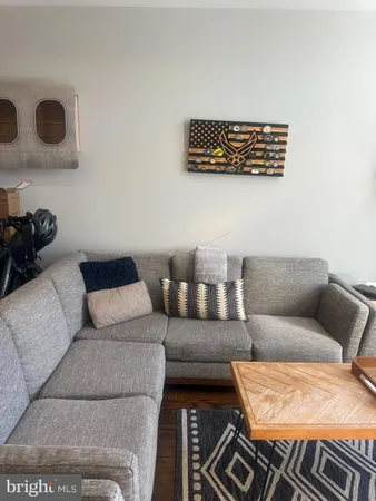 a living room with furniture and a lamp