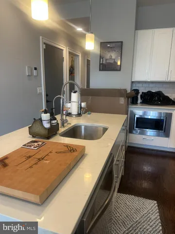 a kitchen with a sink and a stove top oven