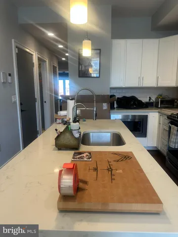 a kitchen with kitchen island sink stove and refrigerator