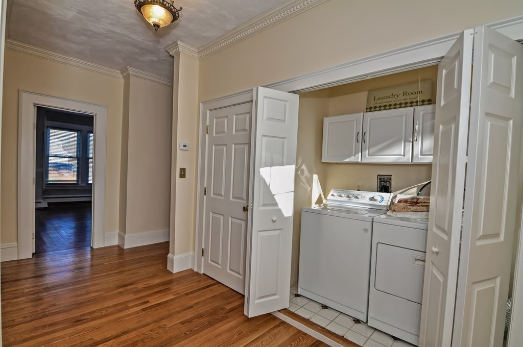 87-89 Pleasant Street Needham, MA 02492 - Photo 13 of 30 a kitchen with a refrigerator and cabinets