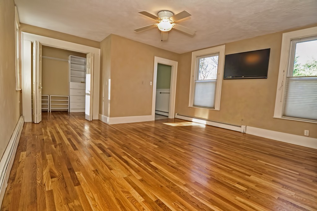 87-89 Pleasant Street Needham, MA 02492 - Photo 14 of 30 a view of a livingroom with wooden floor and a ceiling fan