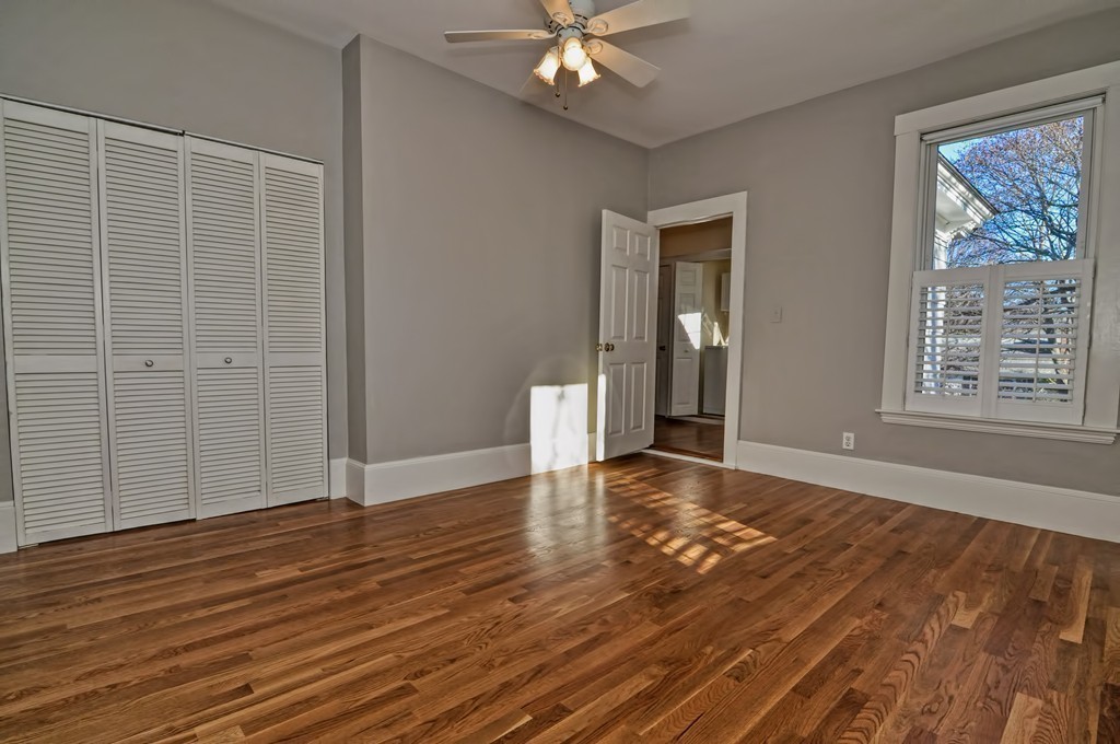 87-89 Pleasant Street Needham, MA 02492 - Photo 16 of 30 a view of an empty room with wooden floor and a window