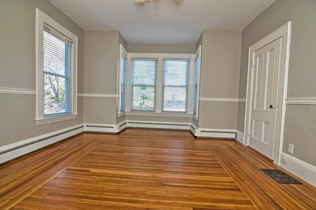 87-89 Pleasant Street Needham, MA 02492 - Photo 17 of 30 an empty room with wooden floor and windows