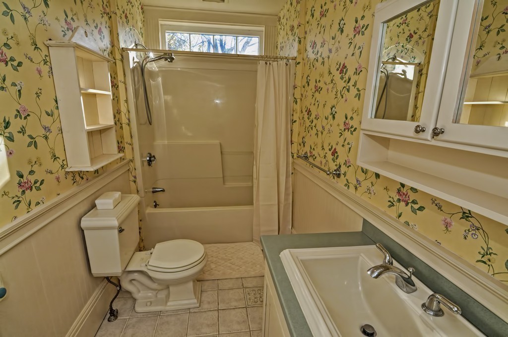 87-89 Pleasant Street Needham, MA 02492 - Photo 19 of 30 a bathroom with a granite countertop toilet sink and shower
