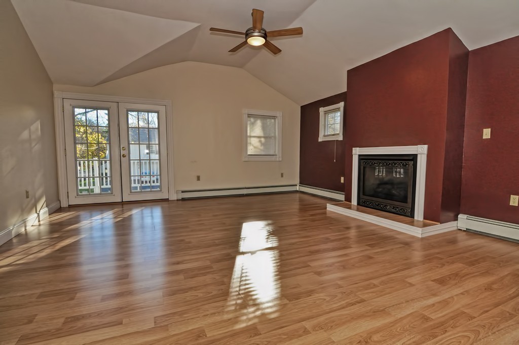 87-89 Pleasant Street Needham, MA 02492 - Photo 24 of 30 an empty room with wooden floor fireplace and windows