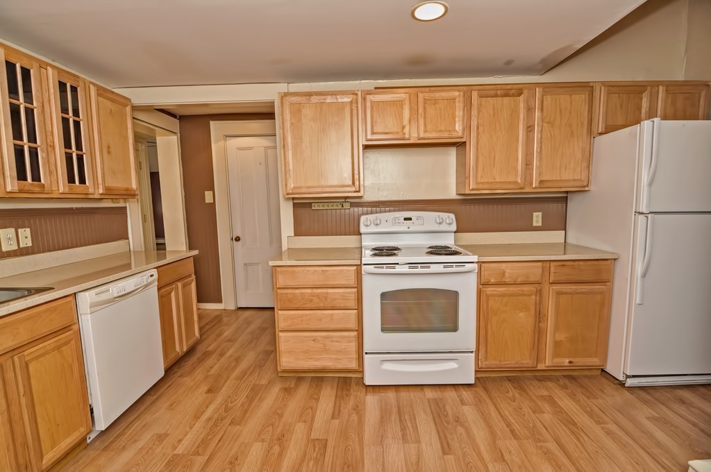 87-89 Pleasant Street Needham, MA 02492 - Photo 28 of 30 a kitchen with white cabinets and white appliances