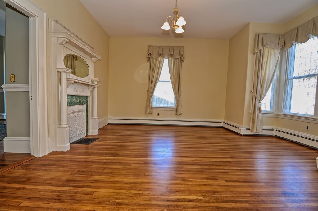 87-89 Pleasant Street Needham, MA 02492 - Photo 6 of 30 wooden floor in an empty room with a window