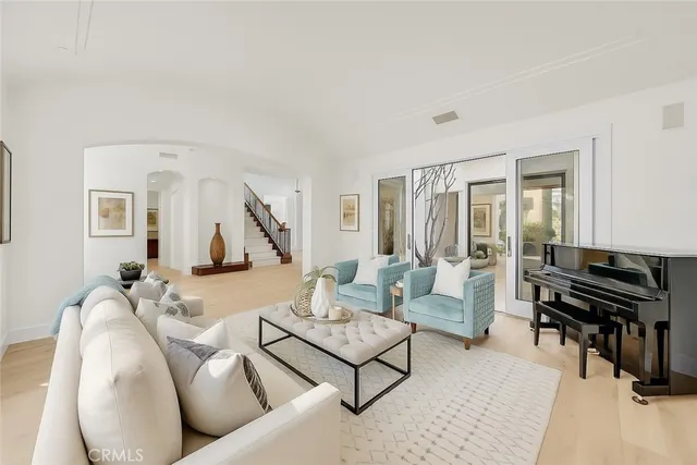 a large kitchen with kitchen island a stove a sink a oven and a refrigerator with wooden floor