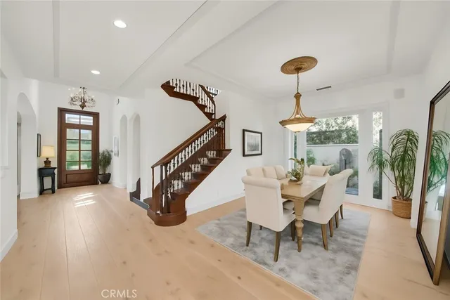 a kitchen with stainless steel appliances kitchen island granite countertop a dining table and chairs
