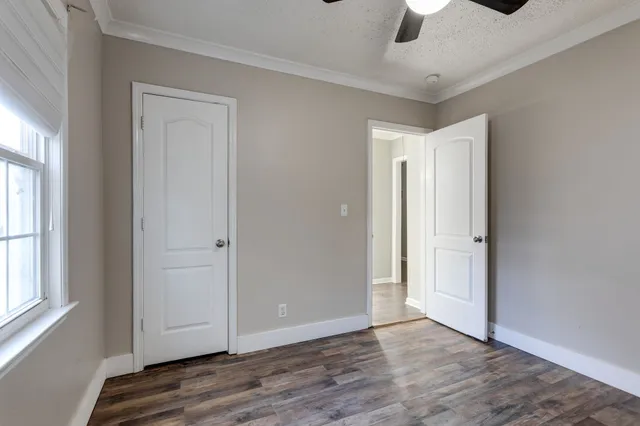 wooden floor in an empty room with a window