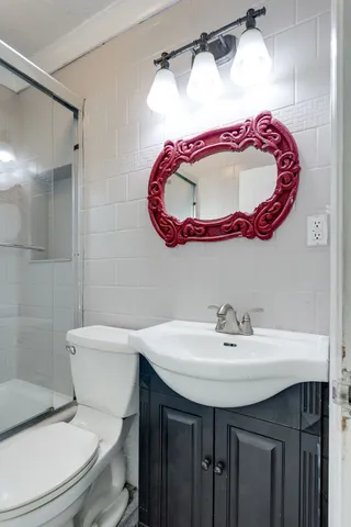 a bathroom with a toilet and a shower