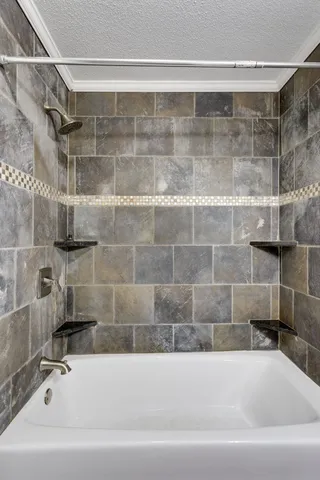 a front view of house with yard and trees in the background