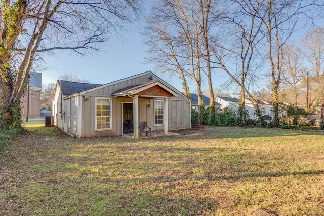 a backyard of a house with fountain and barbeque oven