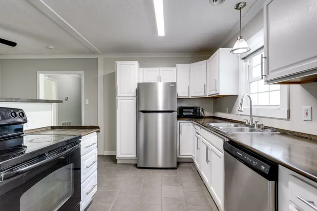 wooden floor in an empty room with a kitchen