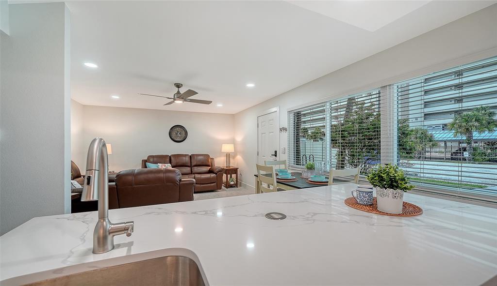 5950 Midnight Pass Road, Unit 201 Sarasota, FL 34242 - Photo 13 of 36 a living room with furniture and a large window