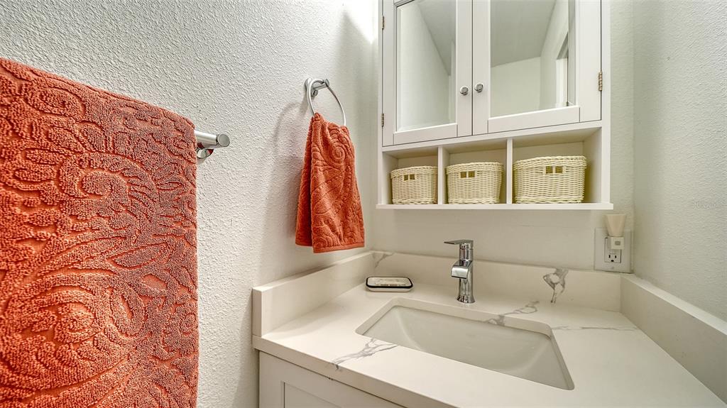 5950 Midnight Pass Road, Unit 201 Sarasota, FL 34242 - Photo 16 of 36 a bathroom with a sink and a mirror