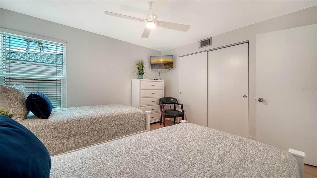 5950 Midnight Pass Road, Unit 201 Sarasota, FL 34242 - Photo 19 of 36 a bedroom with a bed and a fireplace